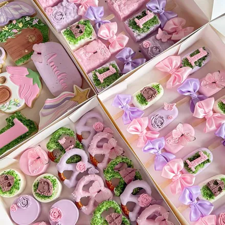 Medium party package with pastel fairy-themed cake pops and pretzel rods, butterflies, roses, and an "Amelia" cookie plaque.